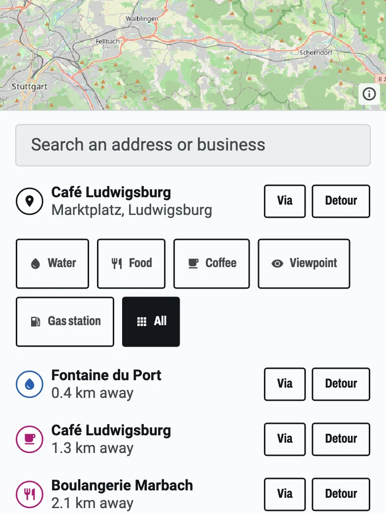 The stop search on the route: Café Ludwigsburg found at the Marktplatz, and a list of nearby stops, each with Via and Detour buttons.